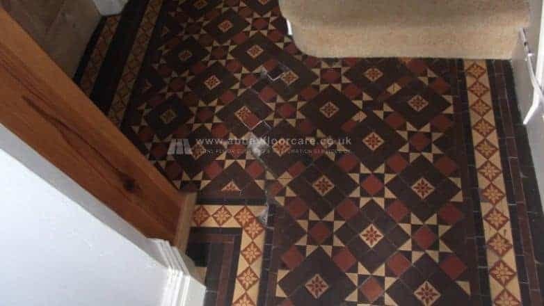 Dull Victorian clay tile hallway in Littleover Derby showing greyed colours and residue before cleaning